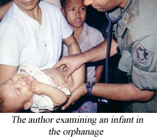 The Author examining an infant in the orphanage.